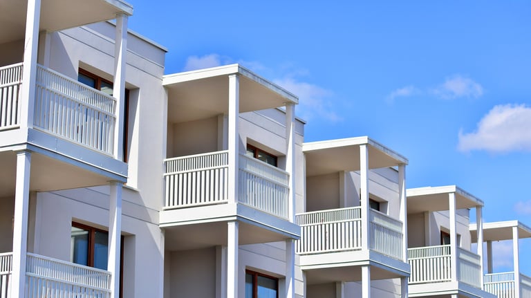 Exterior of new multi-story residential building. Concept of sale and rental of apartments for consumers. Modern windows and balconies.